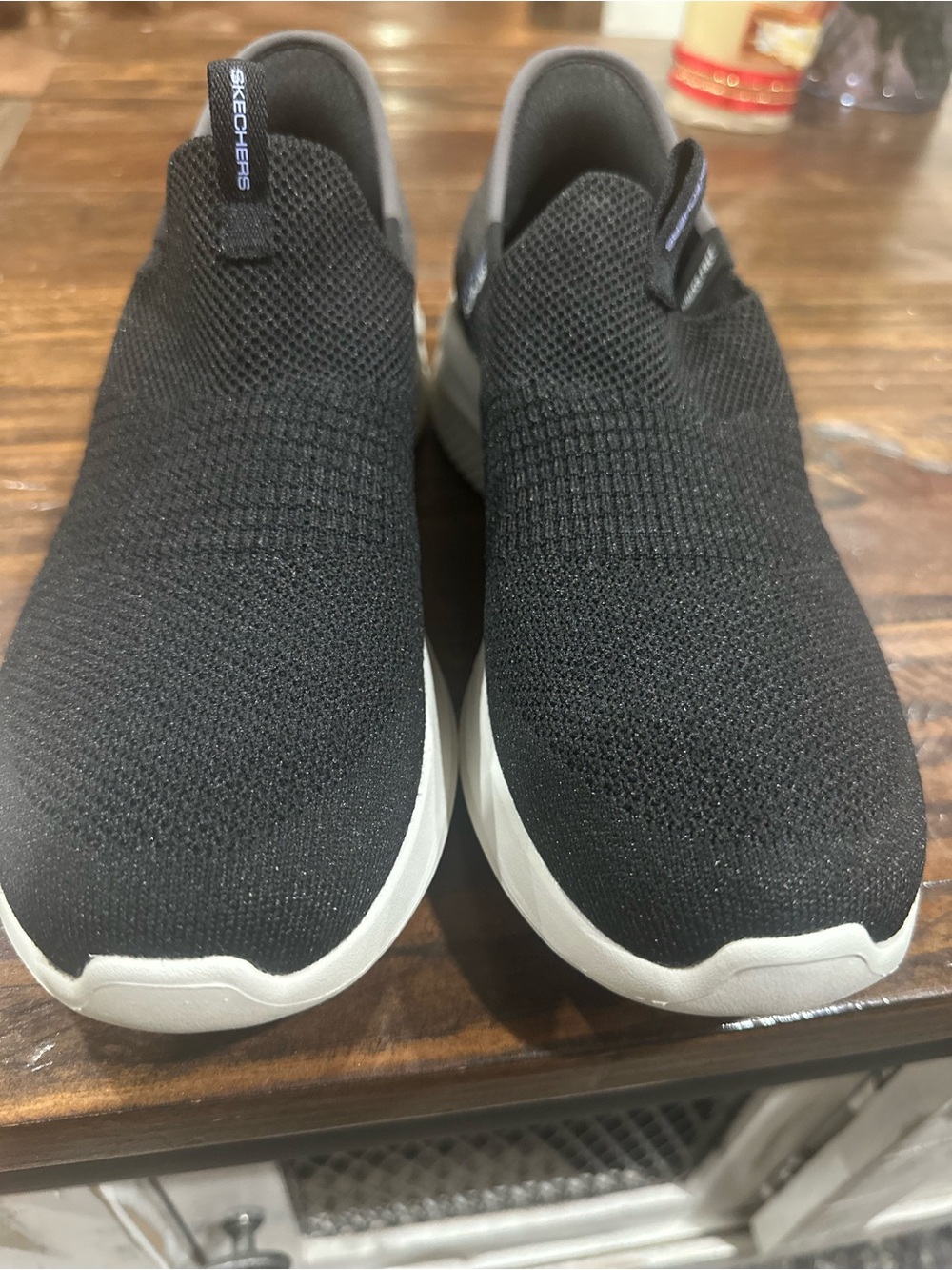 Skechers women’s Black Knit Slip-On Sneakers with White Sole